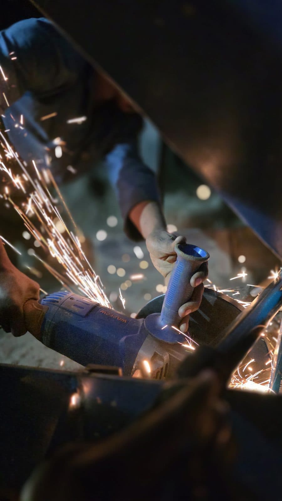 Trailored fabricator grinding steel during washplant fabrication in the shop