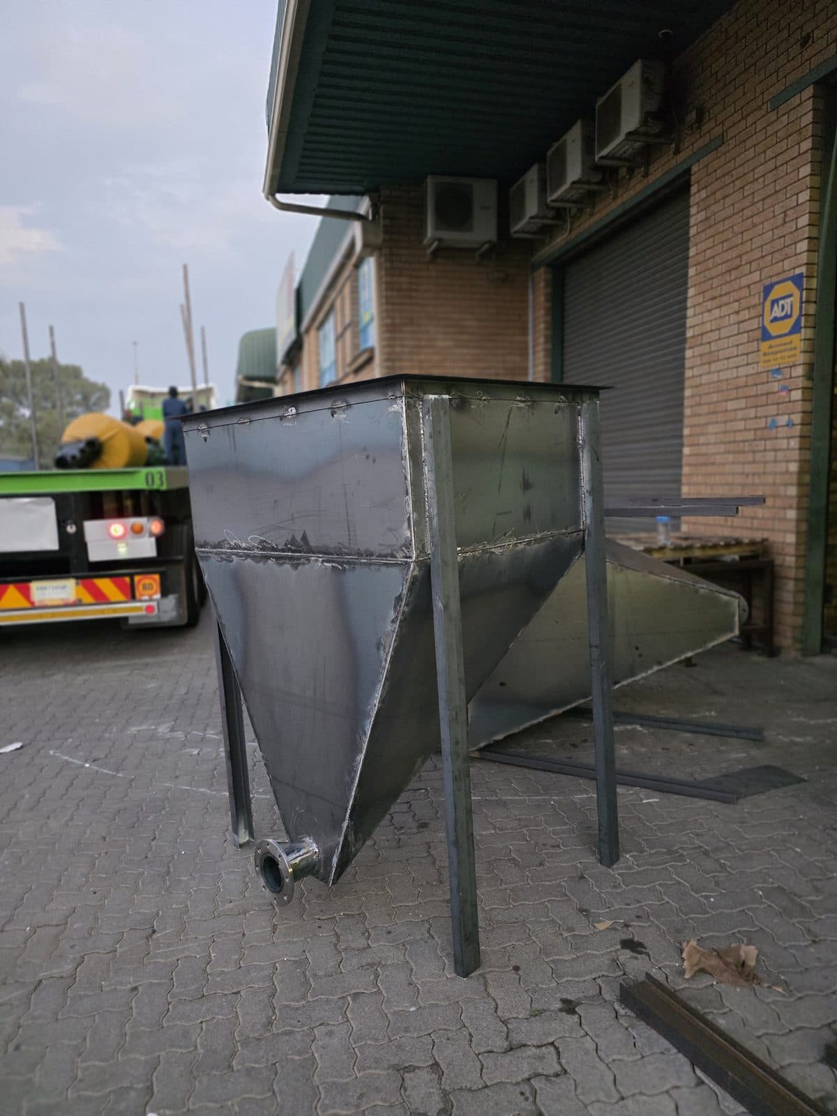 A galvanised feed bin fabricated in the Trailored shop, with the rolled hopper transition and discharge flange