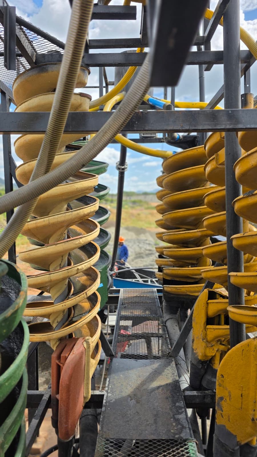 An operator on the fabricated access walkway between the spiral concentrator banks at the Flow Minerals washplant