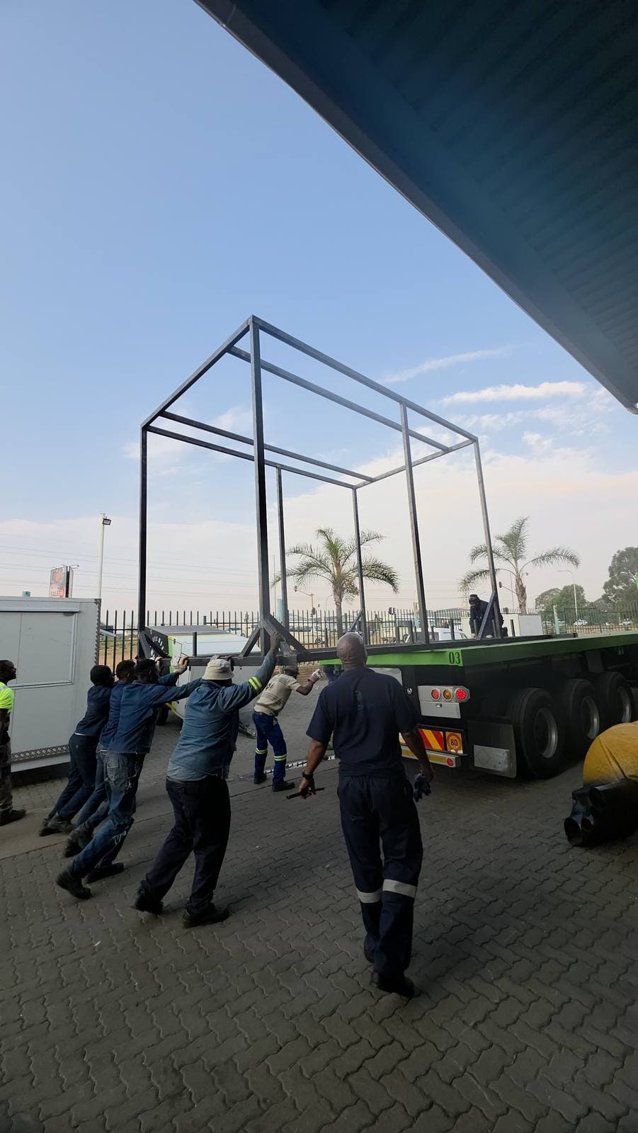 The Trailored team loading the fabricated structure frame onto a flatbed truck for transport to site