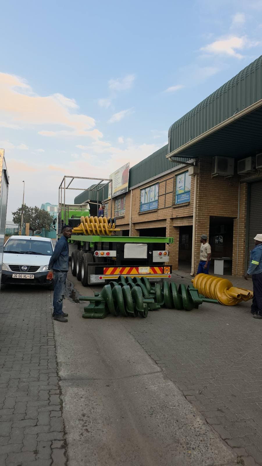 The Trailored team loading spiral concentrators and components onto a flatbed outside the workshop