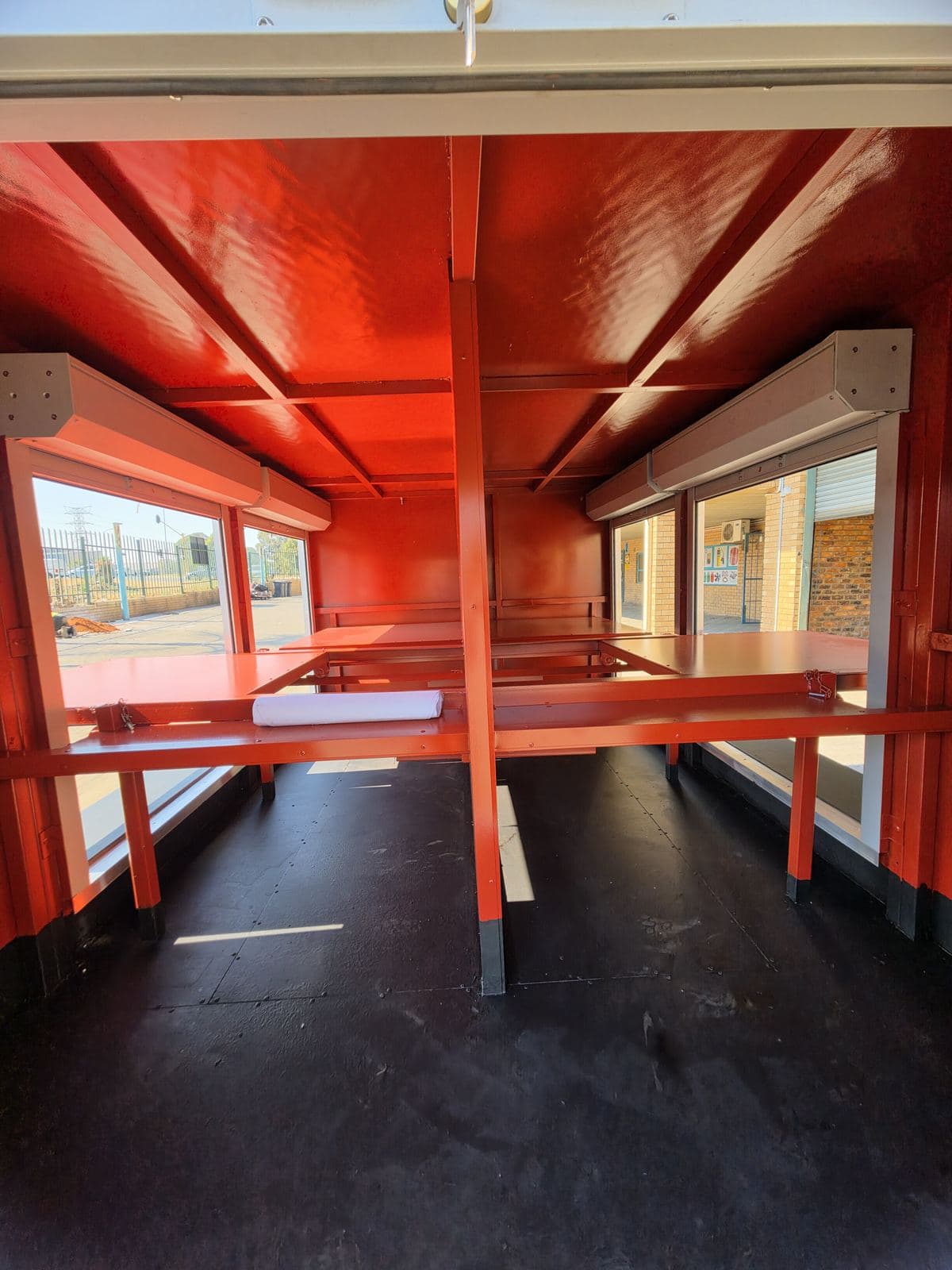 Interior of the hazmat trailer looking along the rubberised aluminium floor with shelves either side.