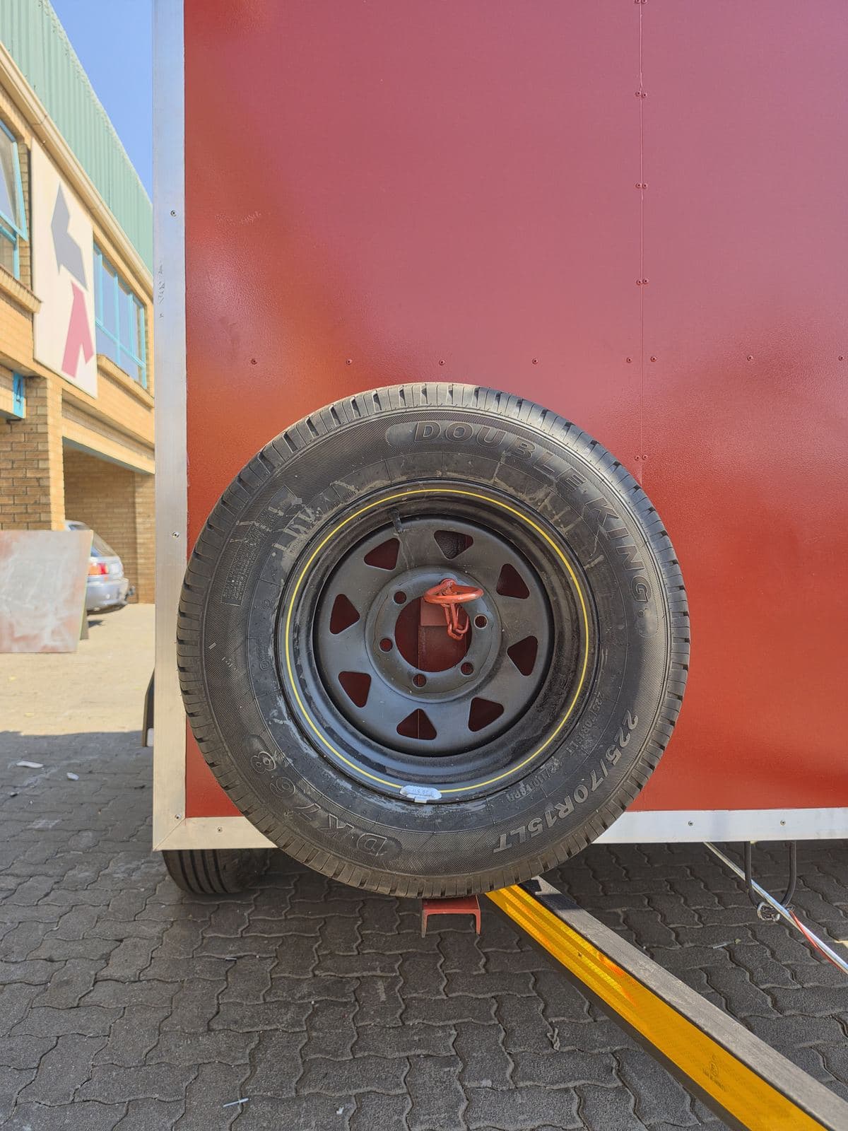 Lockable spare wheel mounted to the side of the hazmat trailer body.