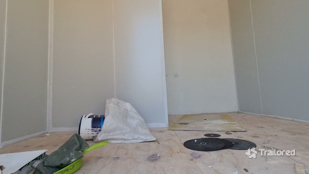 Walkthrough of the conversion in progress, inside and out, with rooms framed and panels going up